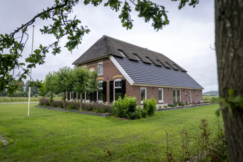 Verbouwde boerderij in Okkenbroek met rieten kap en karakteristiek metselwerk