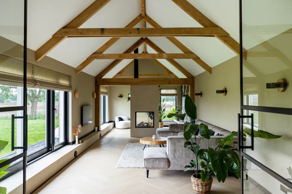 Ruime woonruimte verbouwde jaren 50 boerderij met houten kapconstructie, doorlopende gevelpui en zichtlijnen over het Sallandse landschap.